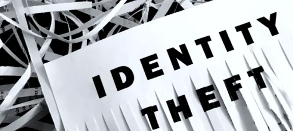 A half shredded piece of paper with the words Identity theft on it